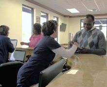 Friendly staff at Bridgeway helping a patient sign in